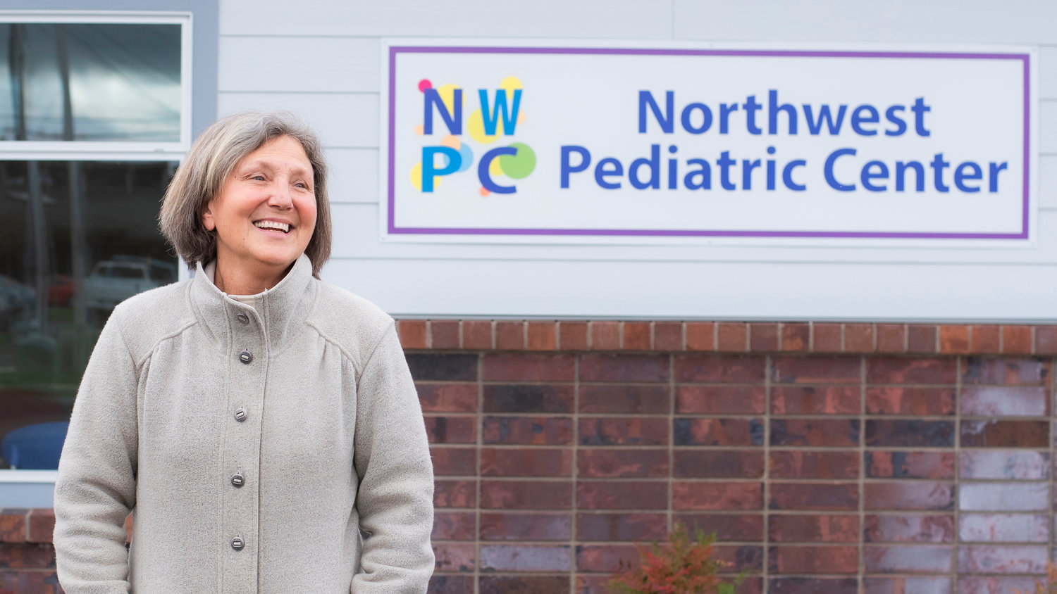 Medical Director Dr. Jennifer Polley smiles while talking about the new banner on display outside the Northwest Pediatric Center in Centralia.